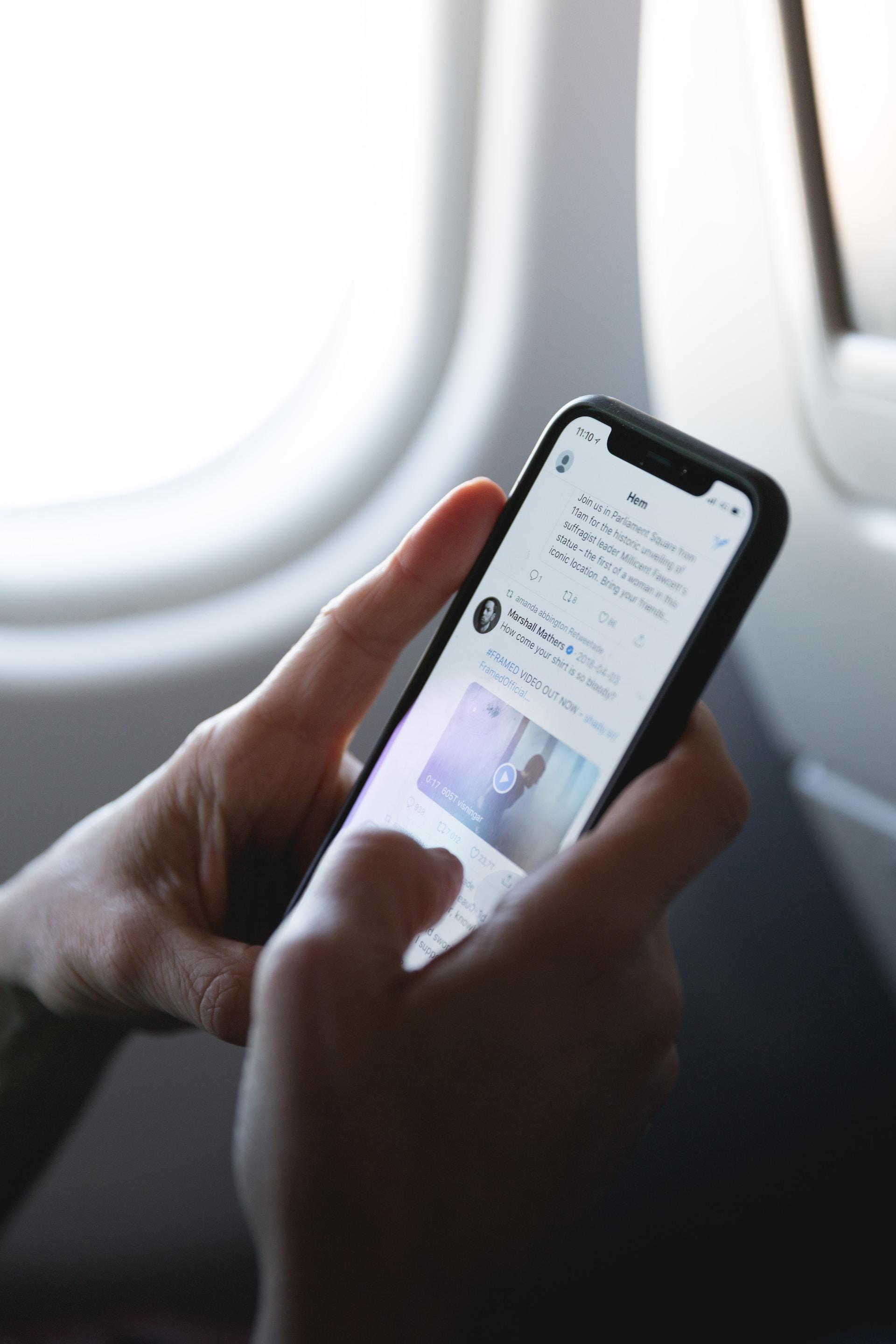 Nutzer am Smartphone postet Social Media Beitrag